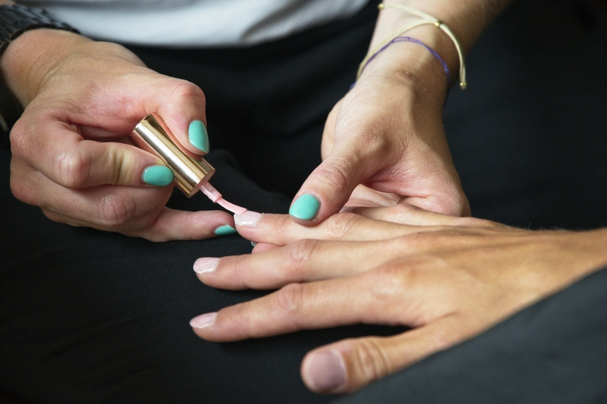 Soft pink polish being brushed on