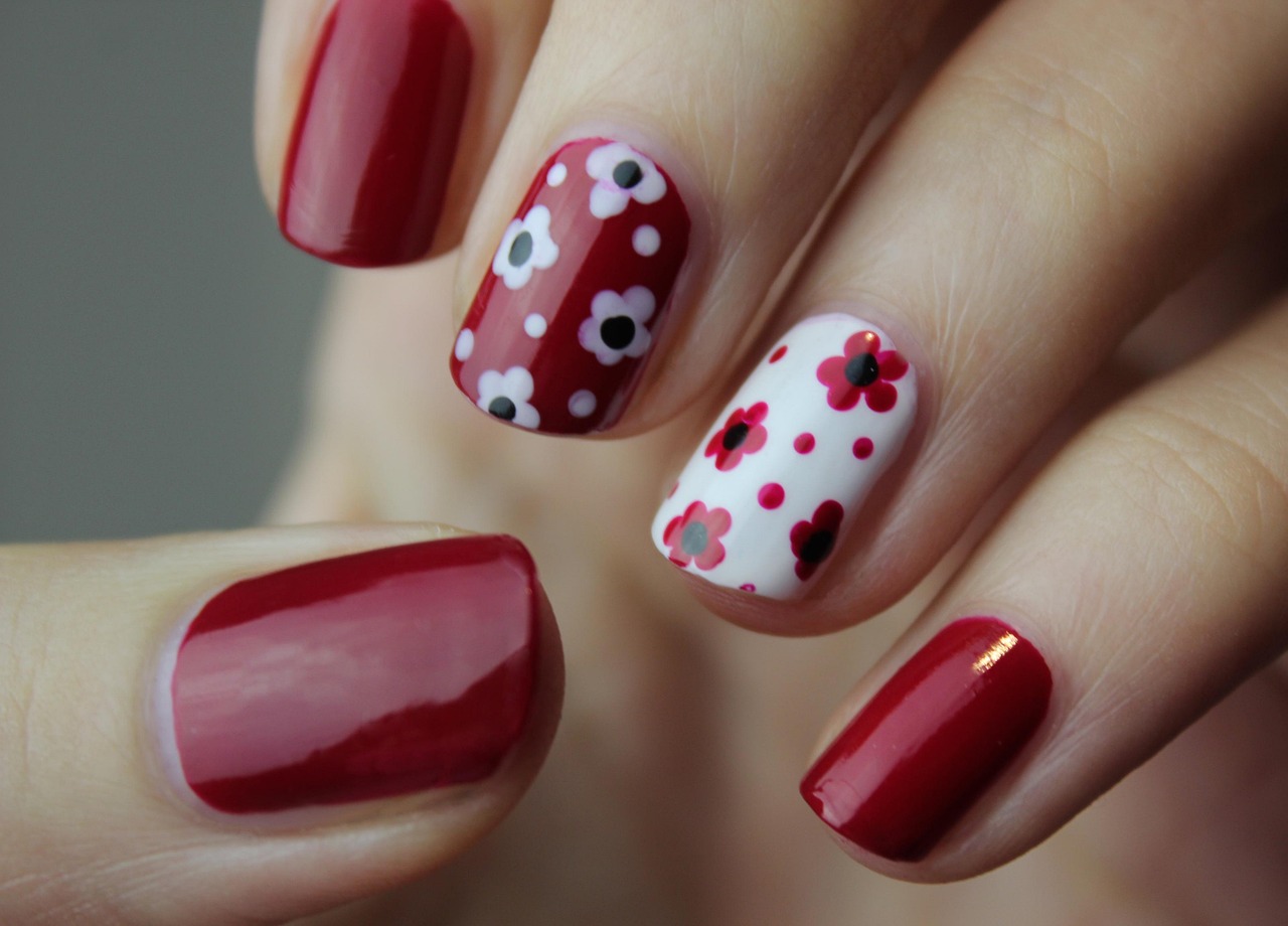 Berry red nails with hand-painted flowers